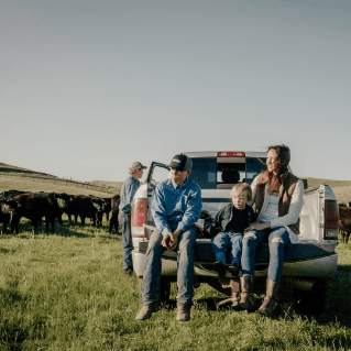 Family sitting at the back of the pickup truck